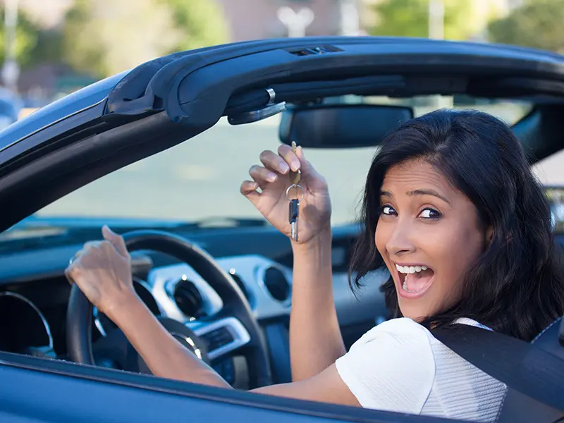 woman in new car holding key