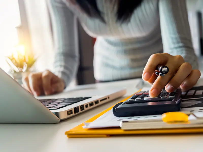 womans hand on calculator
