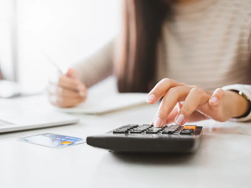 hands doing paperwork with a calculator